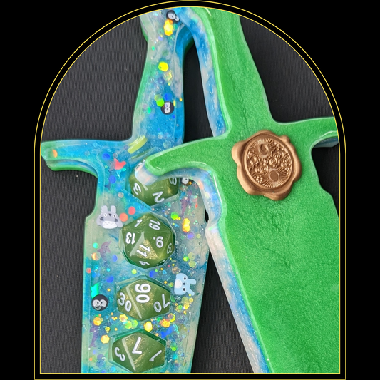 Ghibli Green Dice Holder DaggerUpgrade your game night with this Ghibli-inspired dice dagger! Delight in Totoros and soot sprites delicately set in resin, with green and blue coordinating dice. ThWitchin Waifu
